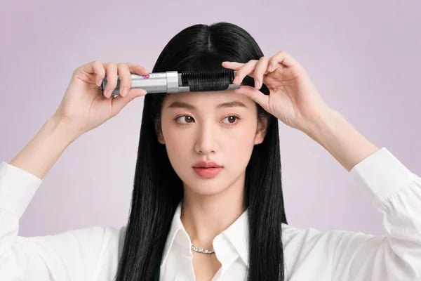 Woman styling her bangs with the K6 cordless mini bang styling brush