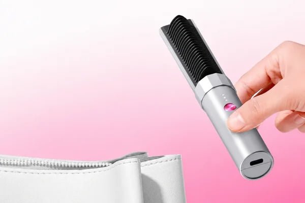 K6 cordless mini bang styling brush beside a cosmetic pouch for portable touch-ups