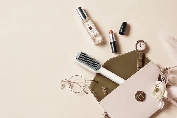 KD680 hair straightening brush displayed with everyday styling accessories