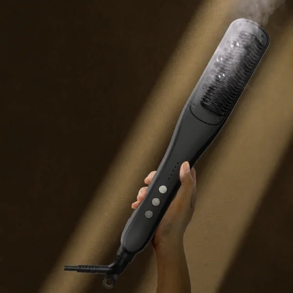 Hand holding the KD880 brush with visible steam around the comb teeth