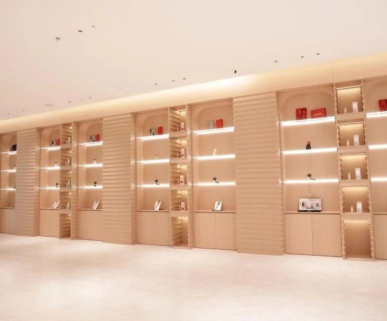 Established product evaluation -- clean B2B sample selection scene featuring mature beauty devices with light packaging and specification materials