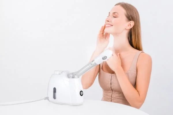 Woman using the KD33S long-tube warm-mist facial steamer