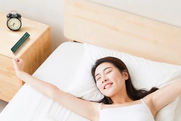 KD88SA portable facial mist device beside a bed in a nighttime skincare setting