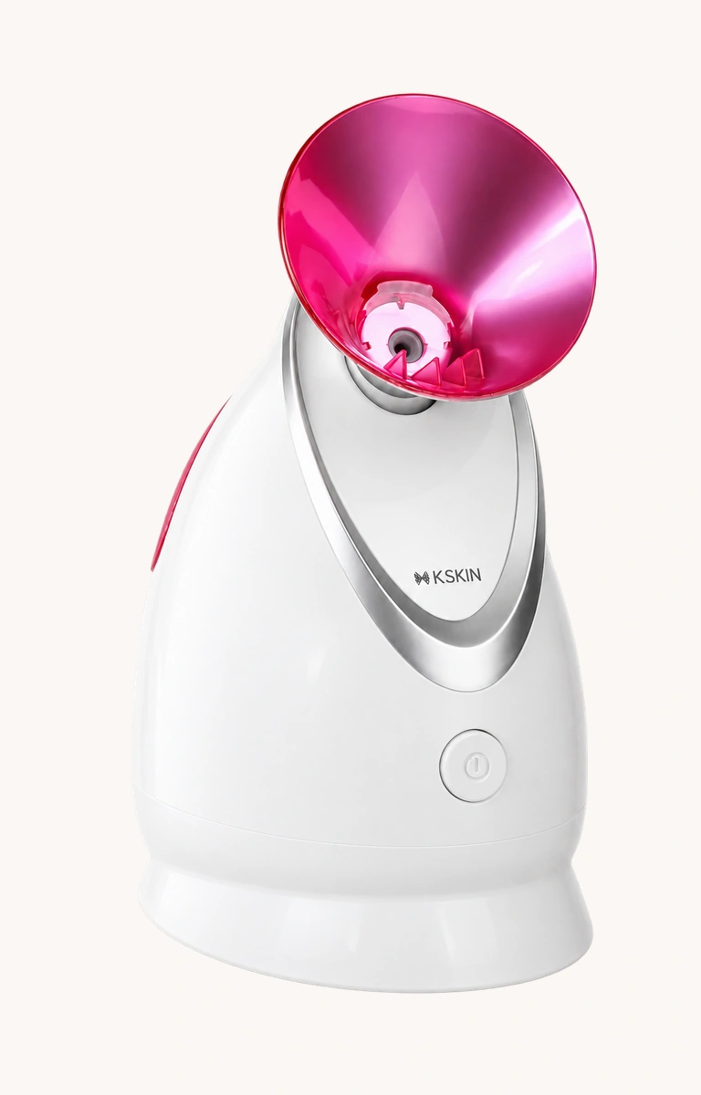 White K·SKIN facial steamer with a metallic magenta nozzle and silver front panel